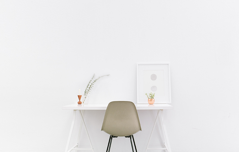 a chair white chair at a
                            white desk on a white wall